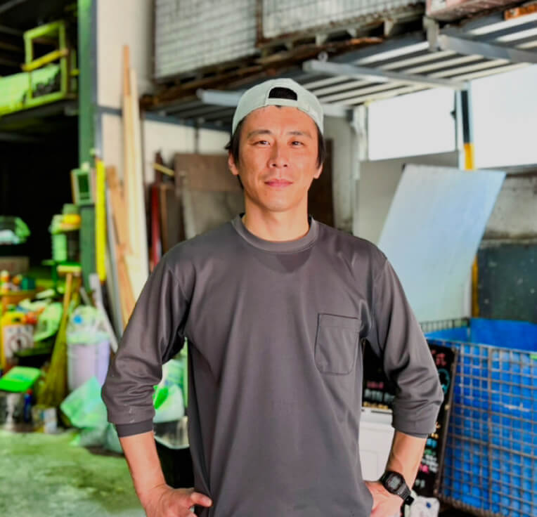 作業場に立つ有限会社松山商店の代表取締役の写真